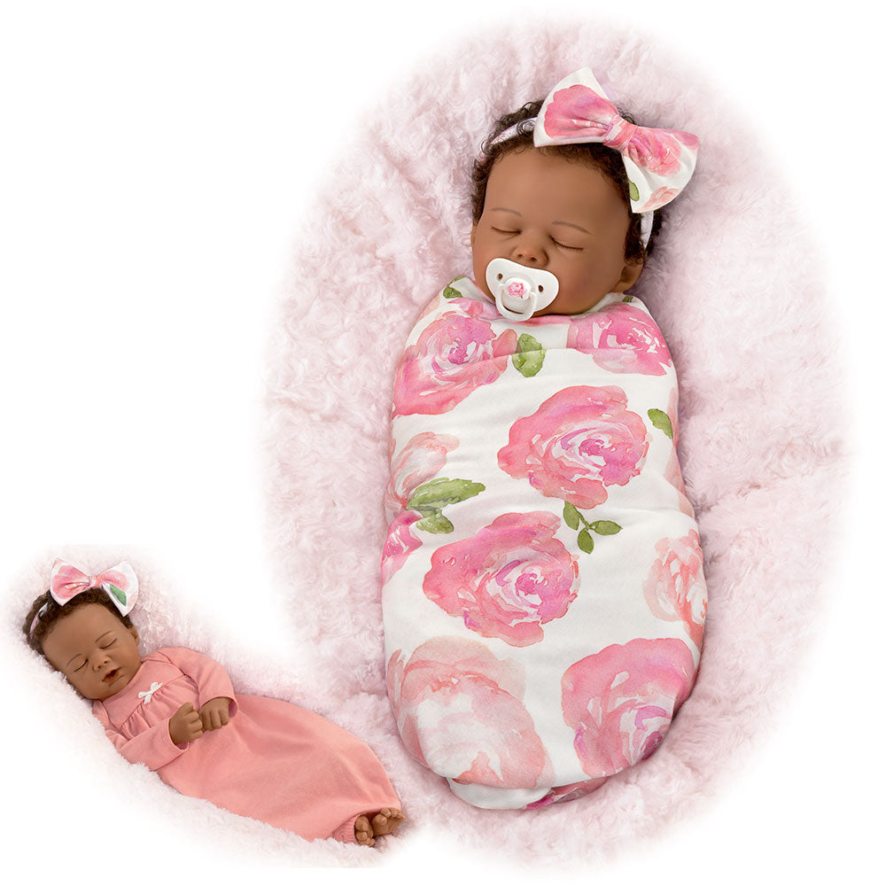 Flora Ashton-Drake baby doll with pink floral blanket and bow headband