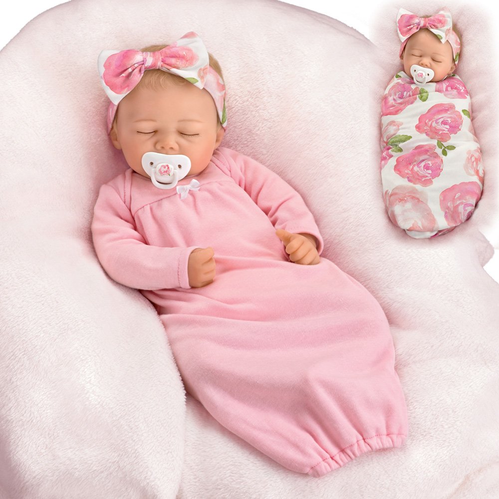 Rosie Ashton-Drake baby doll in pink with floral headband and swaddling blanket